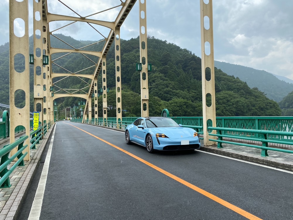 white coupe on gray concrete bridge during daytime