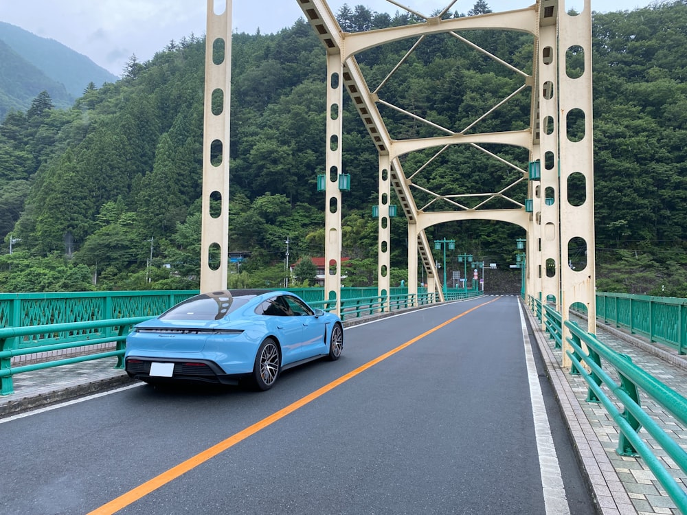 blue porsche 911 on bridge