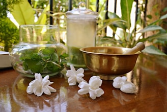 white flower beside green ceramic bowl