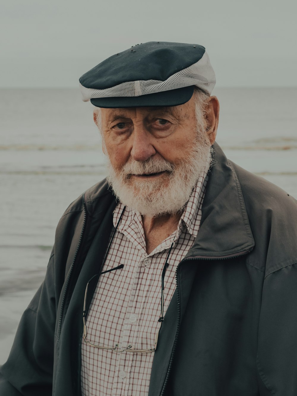 man in black jacket and black and white plaid shirt