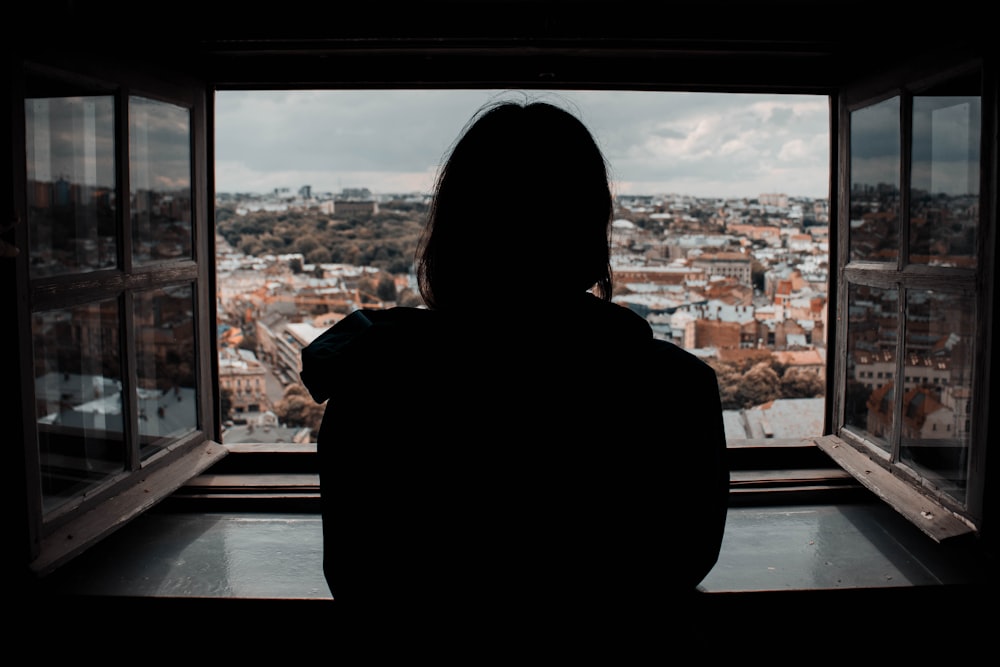 woman looking at the city during daytime