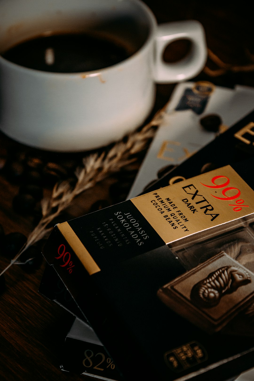 white ceramic mug beside cigarette pack