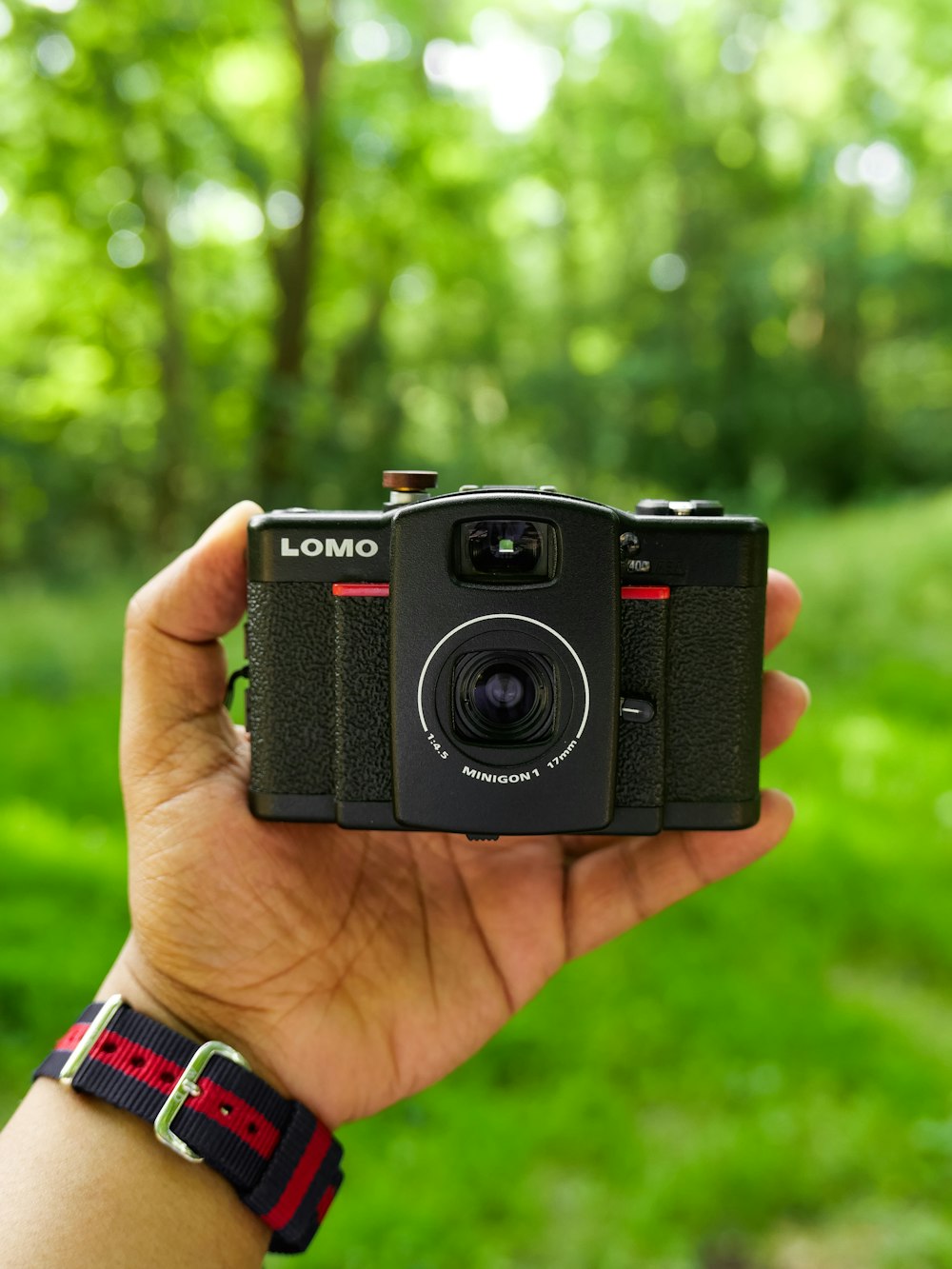 black nikon dslr camera on persons hand