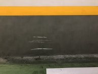 Before and after shot of a stubborn stain on a bathroom wall cleaned with the product.