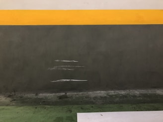 Before and after shot of a stubborn stain on a bathroom wall cleaned with the product.