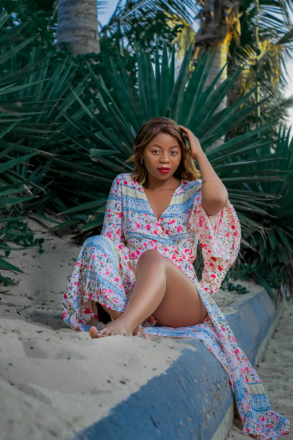 woman in pink and white dress sitting on red hammock