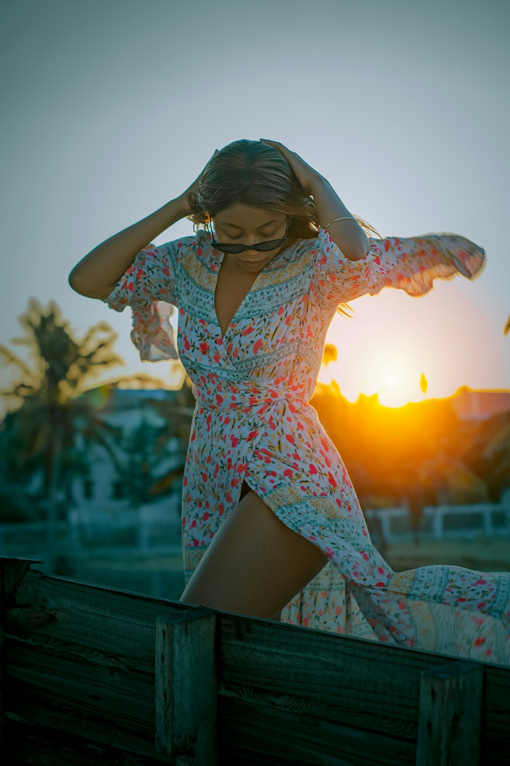 woman in white and red floral dress wearing black sunglasses