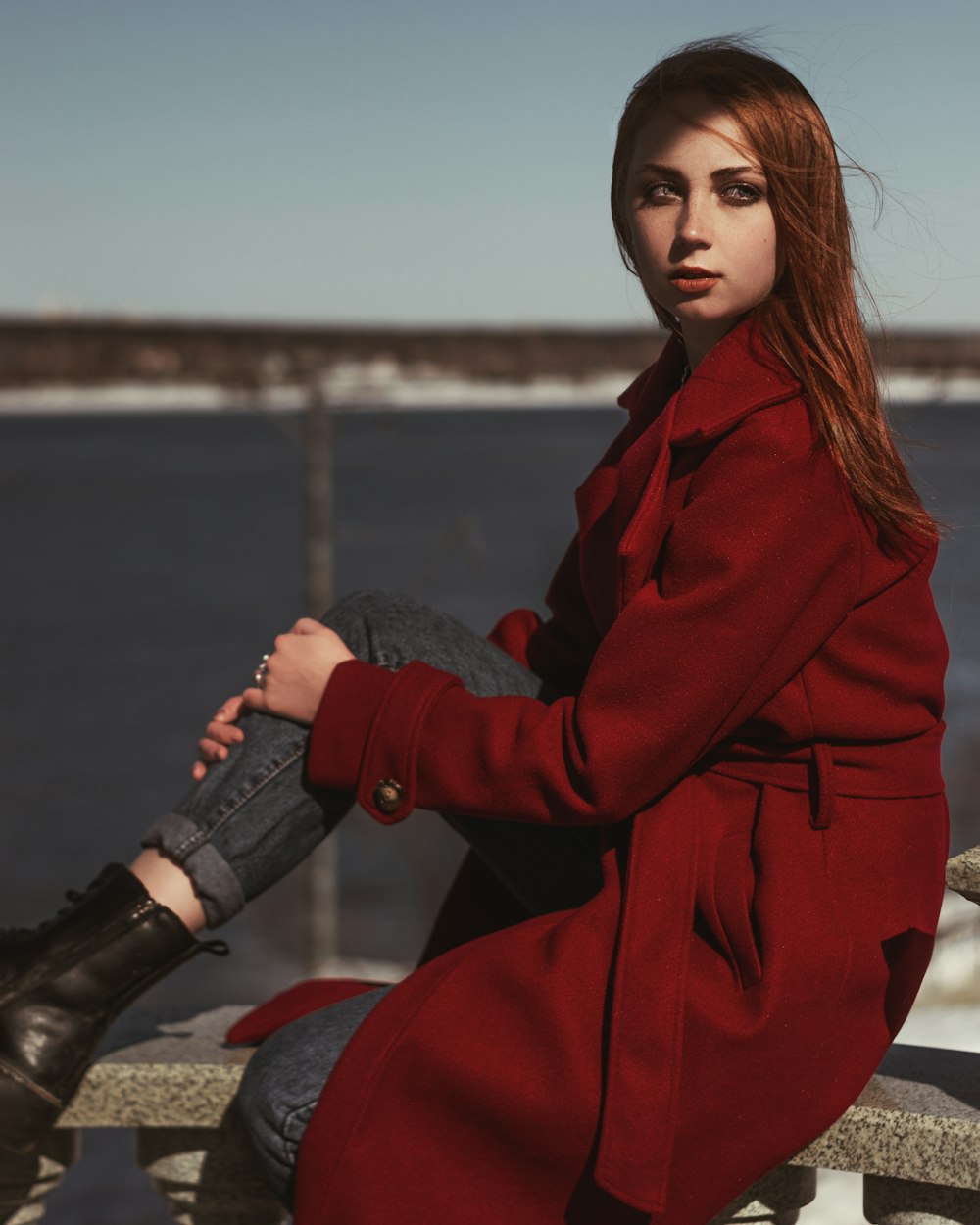 woman in red coat and black denim jeans