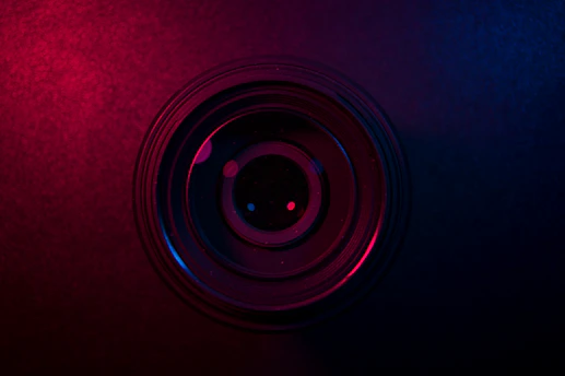 A sleek camera lens reflecting deep purple hues, symbolizing Zonkol Visuals' luxurious videography style.