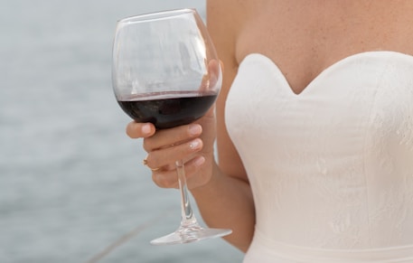 woman in white tank top holding wine glass