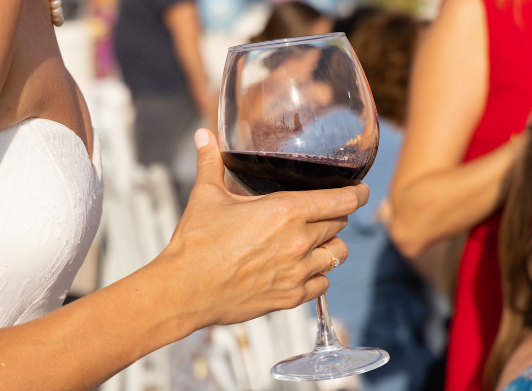 person holding clear wine glass