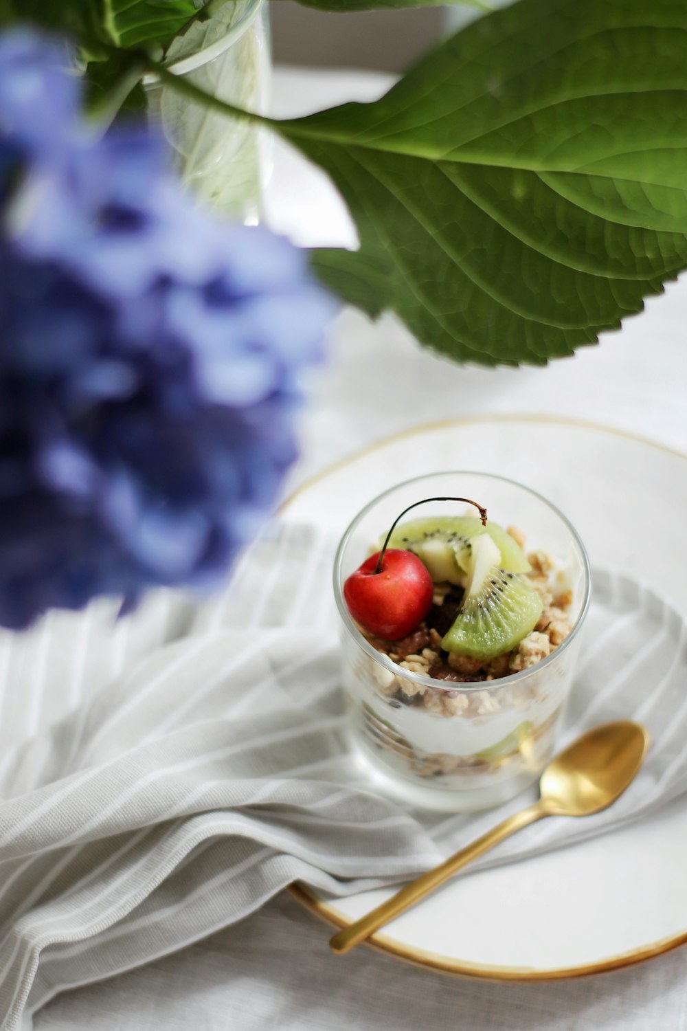 clear glass cup with ice cream and cherry on top