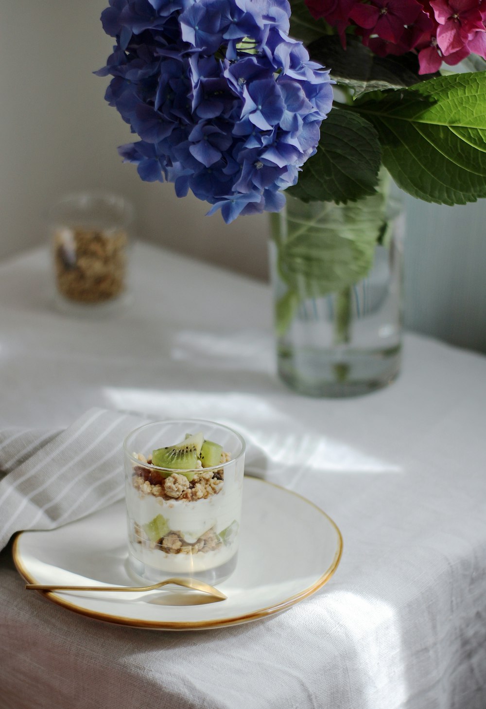 clear glass mug with ice cubes on white ceramic plate