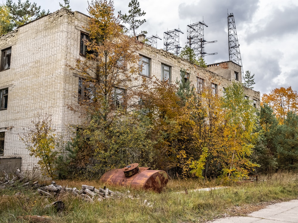 brown and white concrete building near green trees during daytime