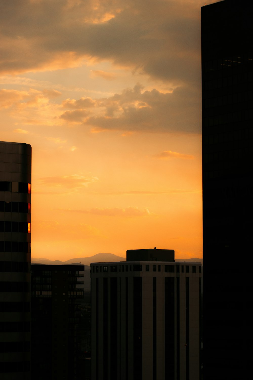 white and brown concrete building under white clouds during daytime