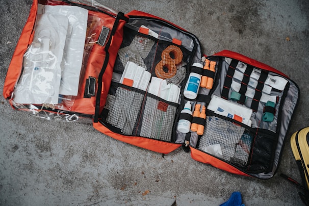 Medical emergency kit with supplies such as bandages, gloves, and defibrillator in a ready-to-use case