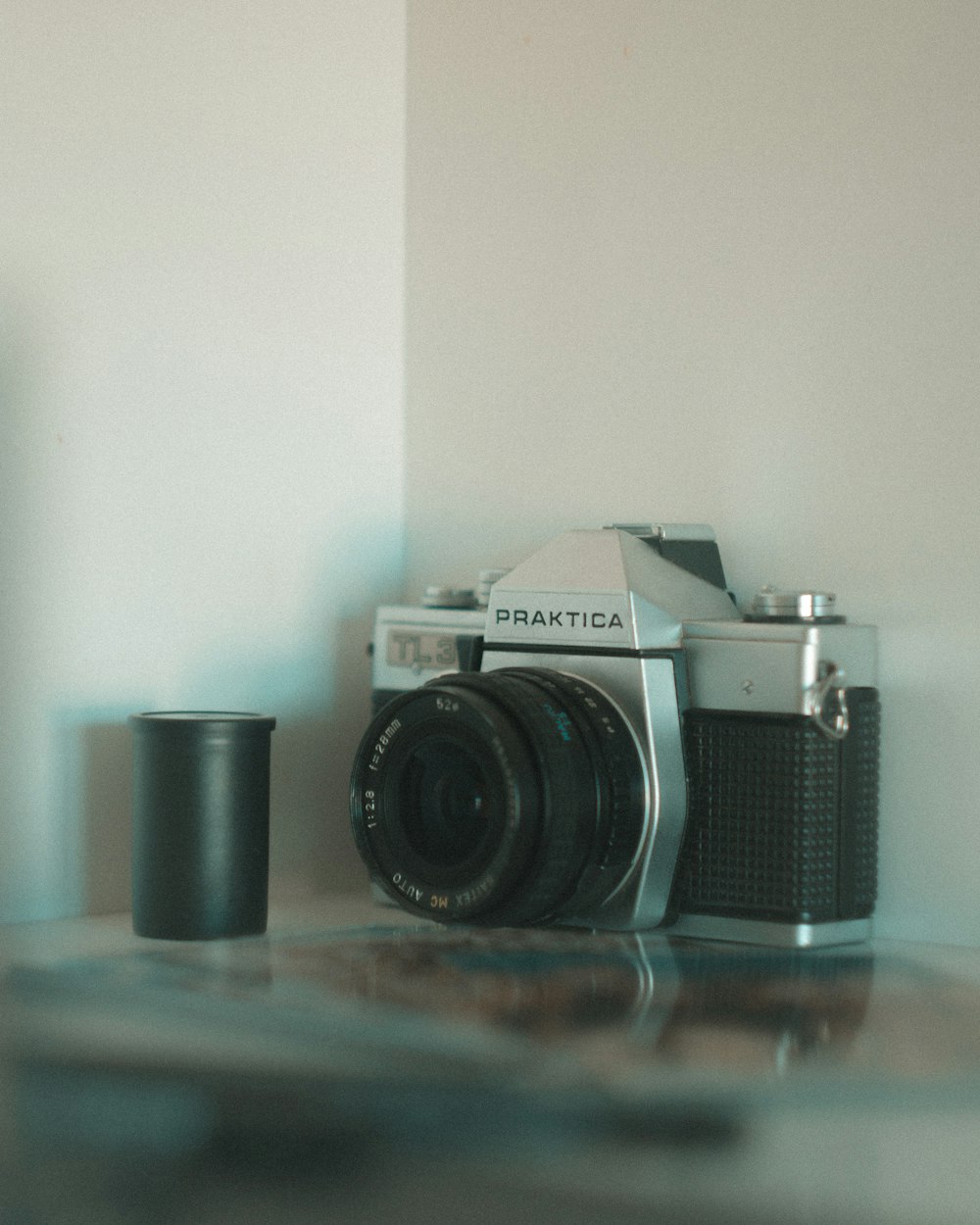 black and silver nikon dslr camera on brown wooden table