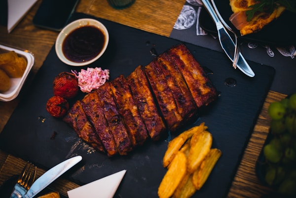 Grilled meat on black plate