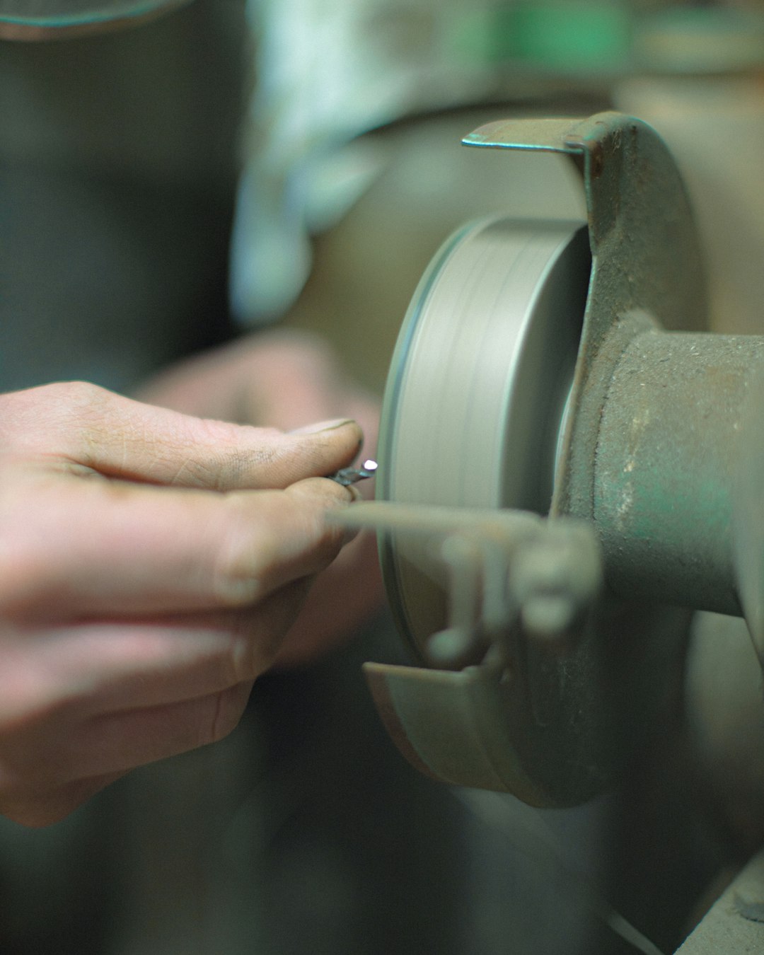 person holding gray metal tool