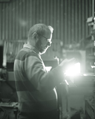 man in gray long sleeve shirt wearing eyeglasses