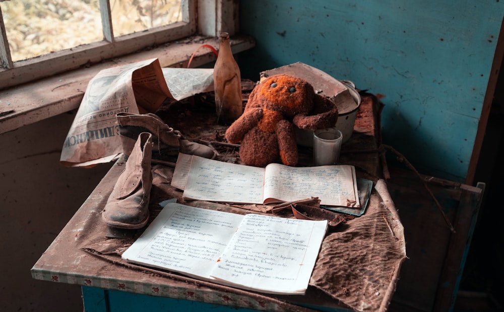 brown bear plush toy on white printer paper