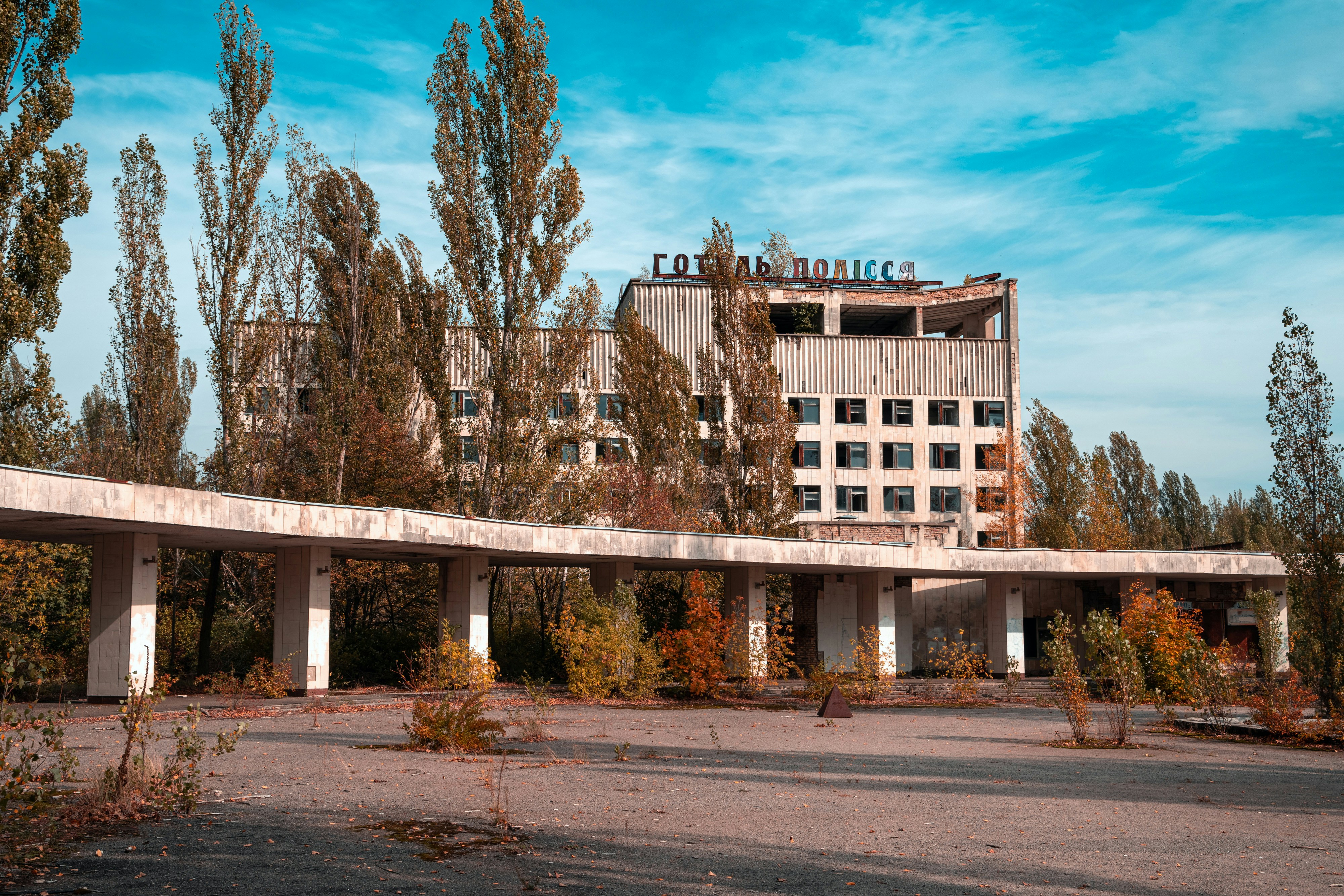 brown concrete building near trees under blue sky during daytime