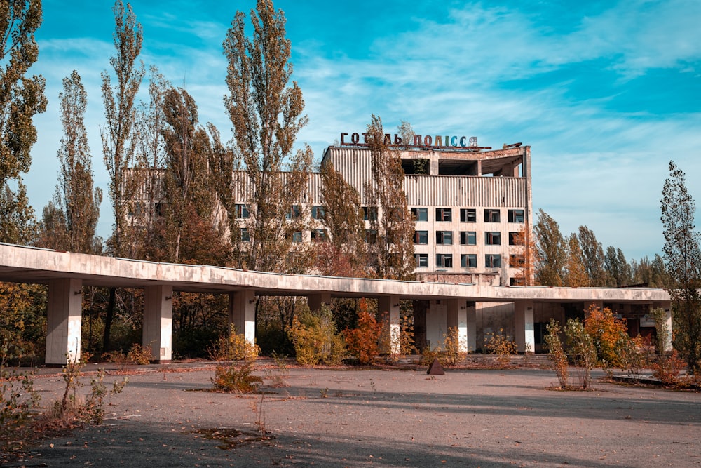 brown concrete building near trees under blue sky during daytime