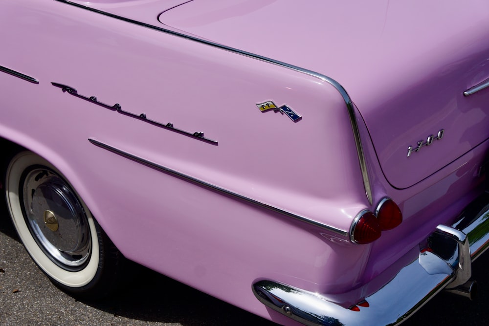 pink chevrolet car on black asphalt road