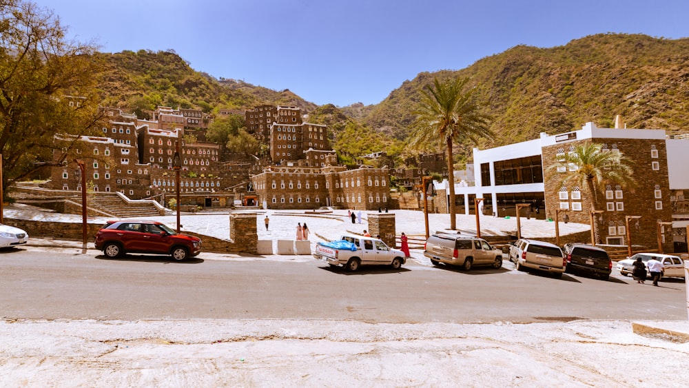 cars parked on side of the road near buildings during daytime