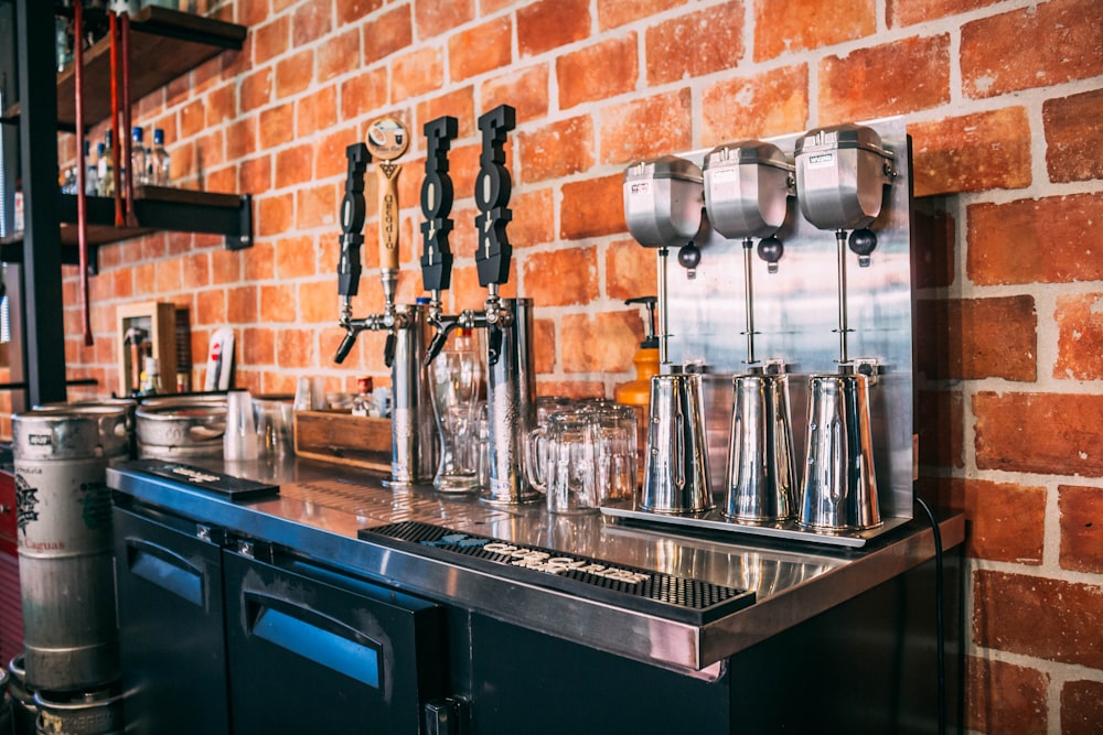 a coffee bar with a brick wall behind it