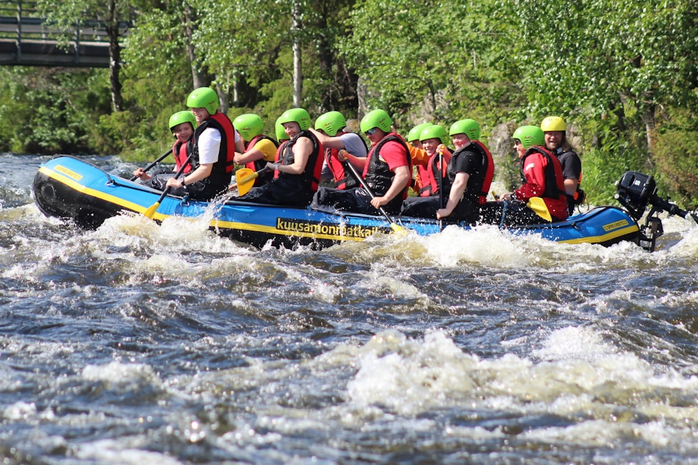 people riding on blue kayak on water during daytime