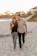 man and woman standing on beach during daytime