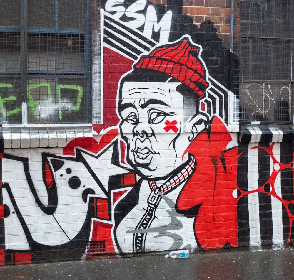 red and black woman graffiti on wall