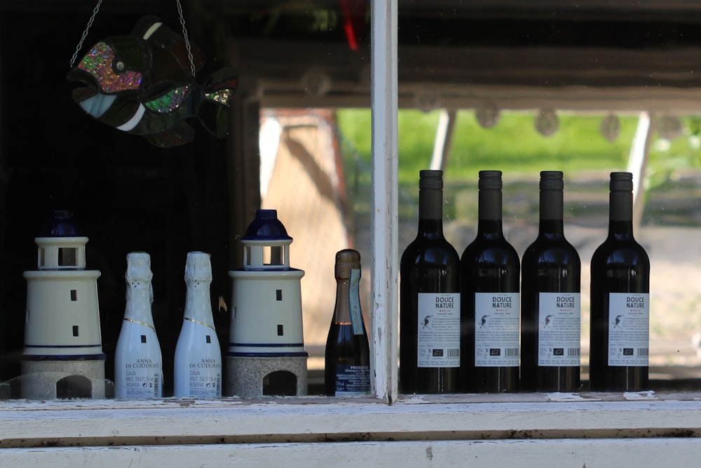 white and black bottles on white wooden table