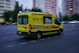 yellow and red ambulance on road during daytime