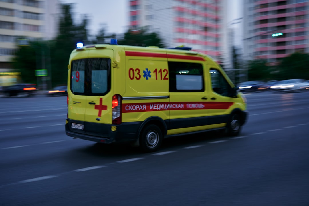 yellow and red ambulance on road during daytime