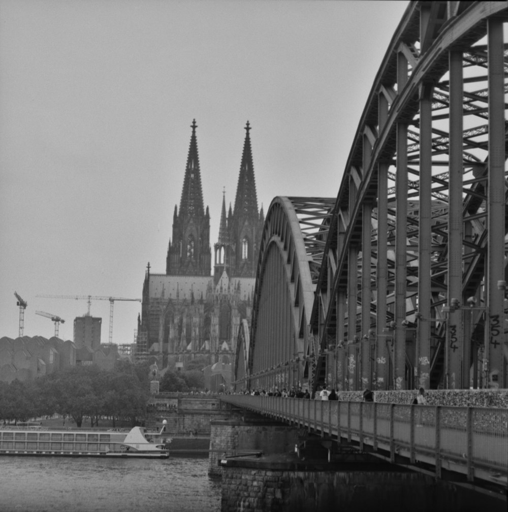 grayscale photo of bridge over river