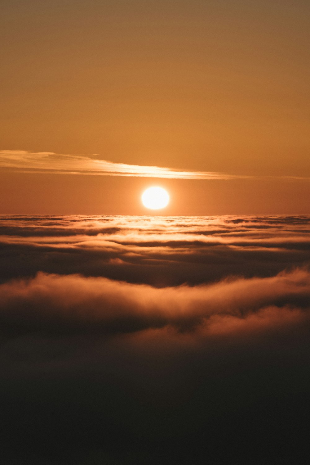 sun setting over the clouds