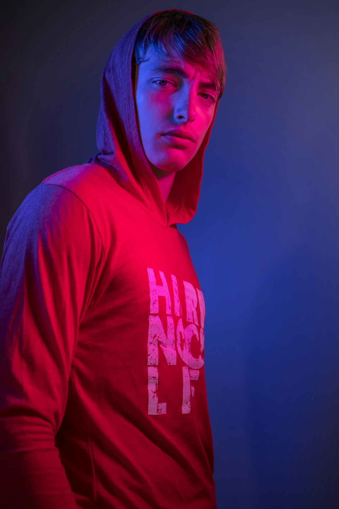 man in red hoodie standing