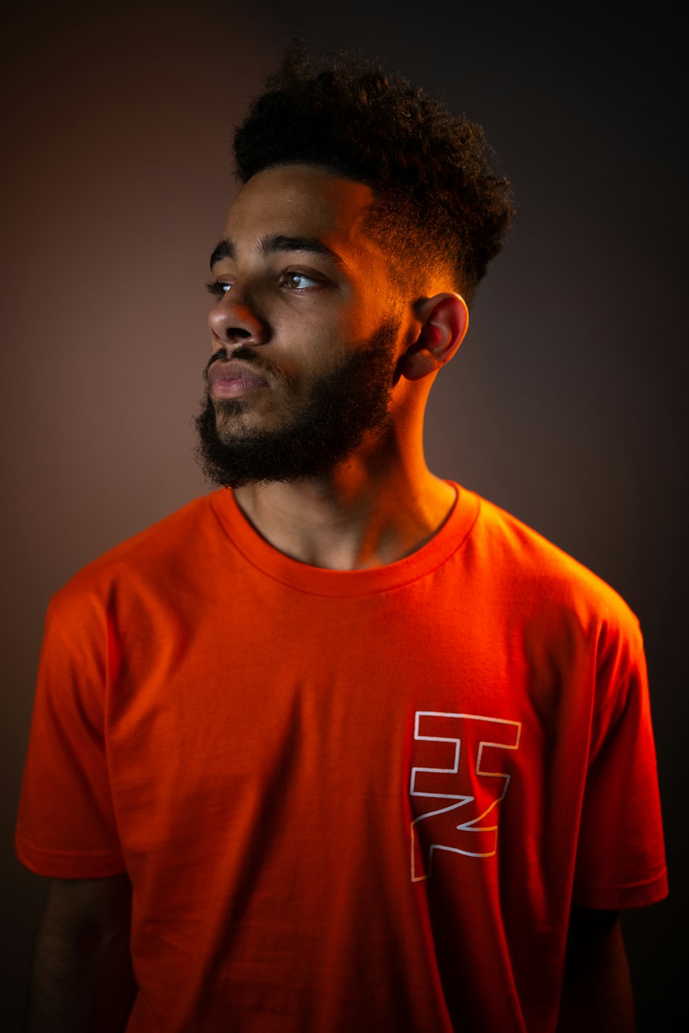 man in orange crew neck t-shirt