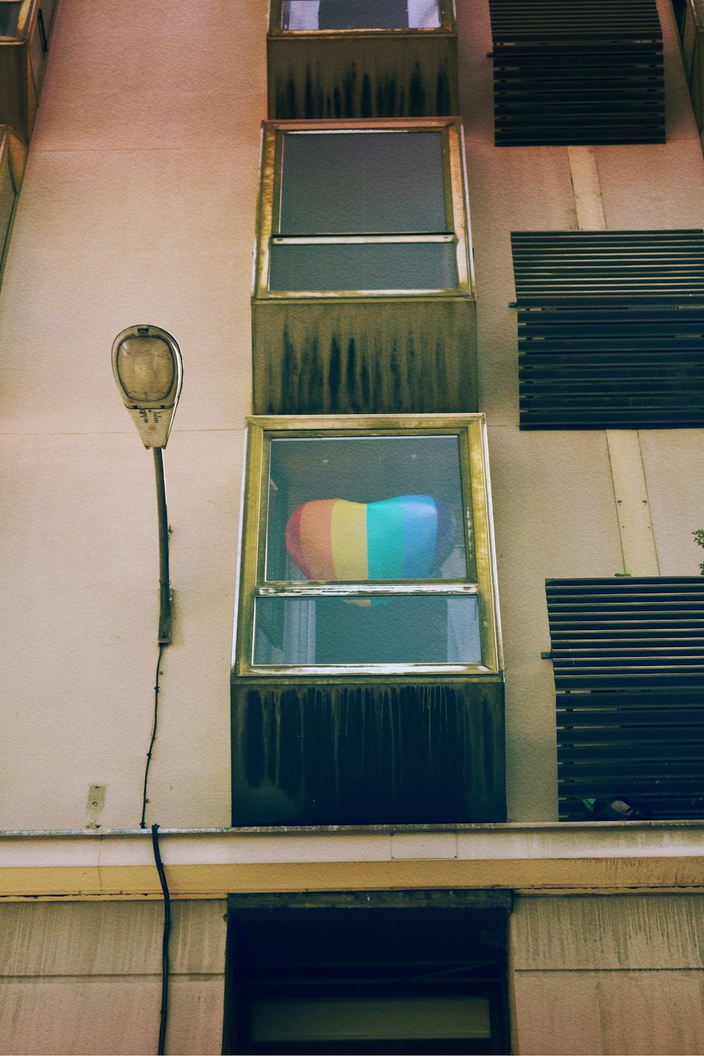 blue wooden window on white concrete building