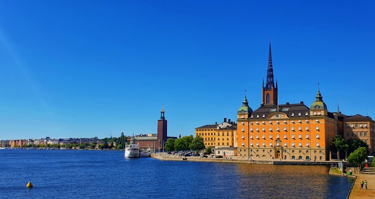 brown concrete building near body of water during daytime