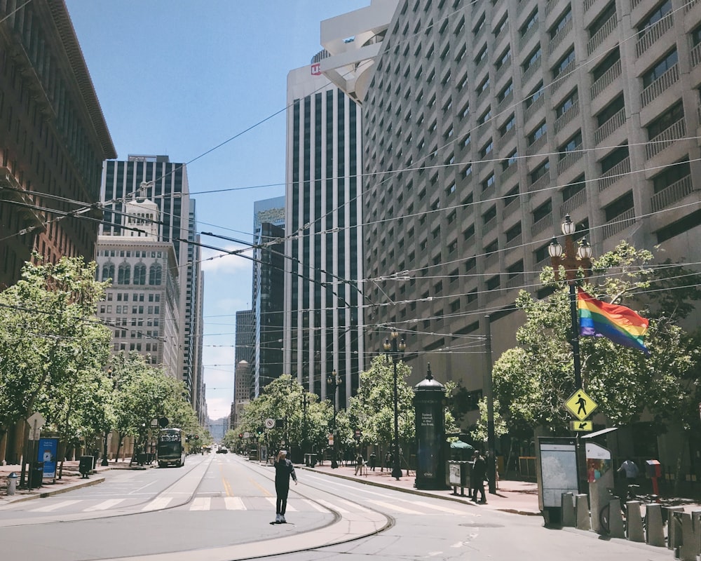 people walking on pedestrian lane near high rise buildings during daytime