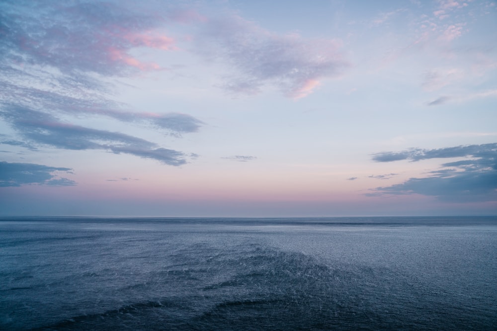 body of water under cloudy sky during daytime