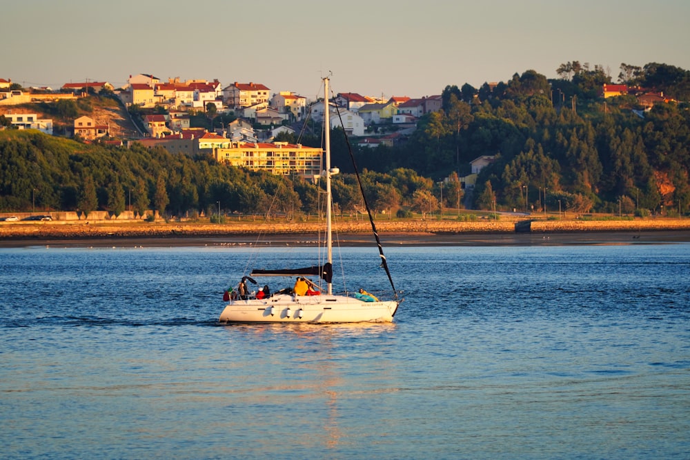 white and yellow boat on water during daytime