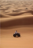 a man riding a four wheeler in the desert