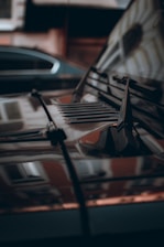Close-up of a shiny car hood reflecting city lights after detailing.