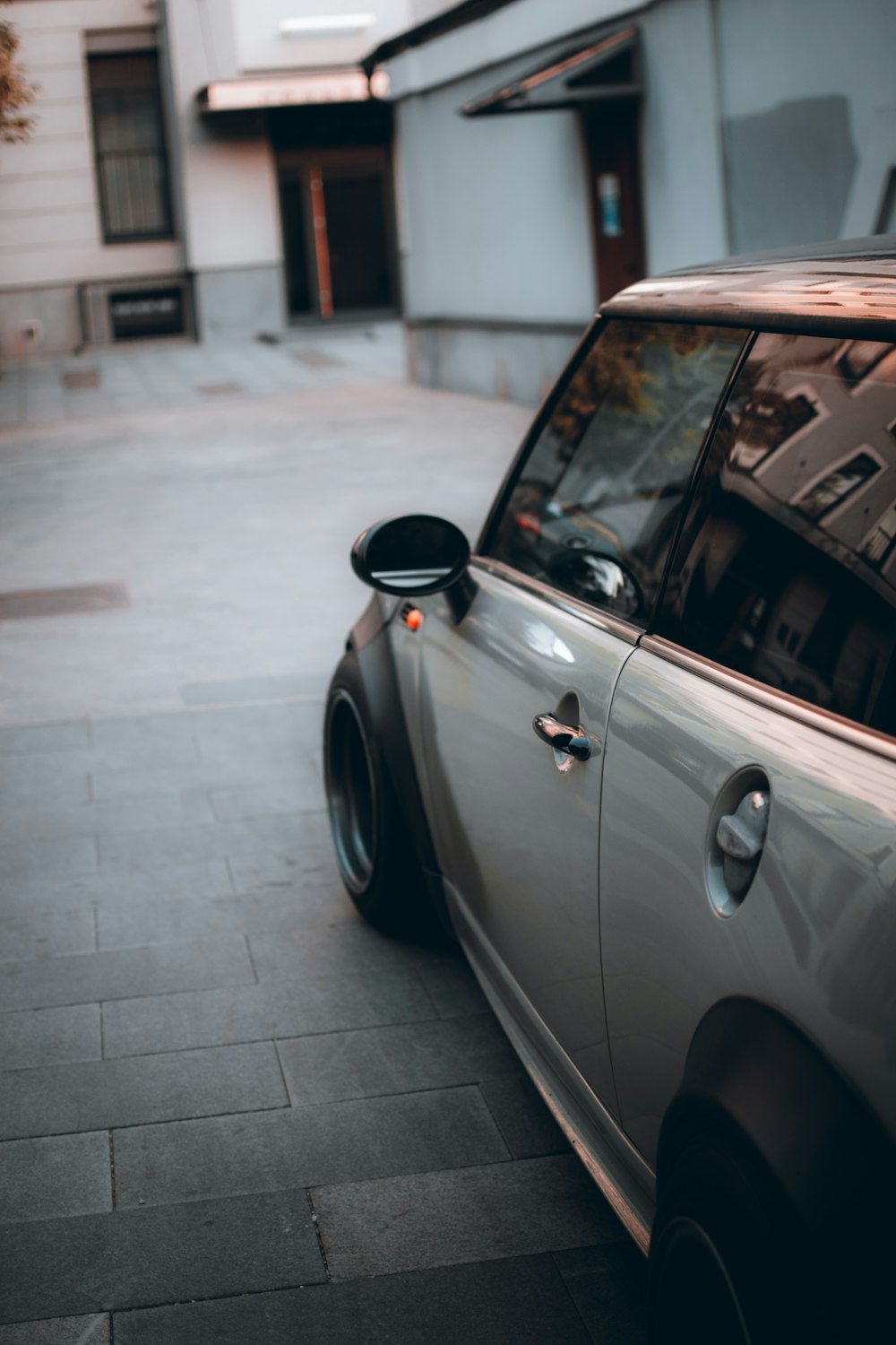 silver car parked on gray concrete floor