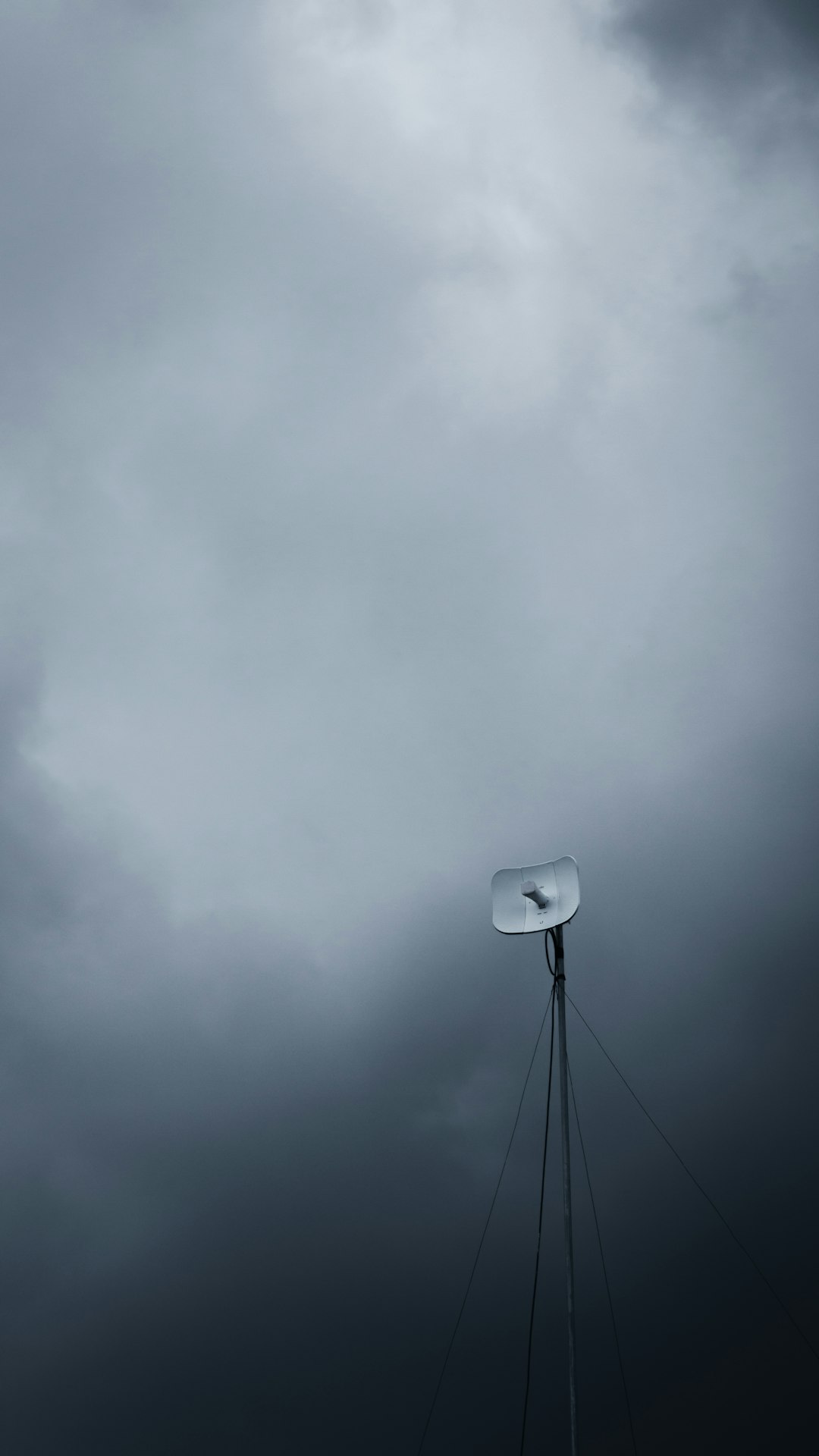 white and black street light under gray clouds