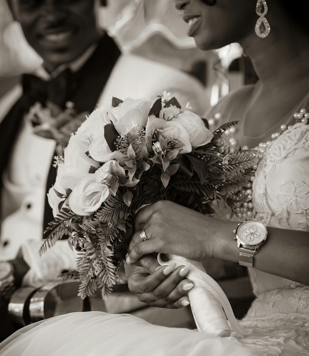 man and woman holding bouquet of flowers